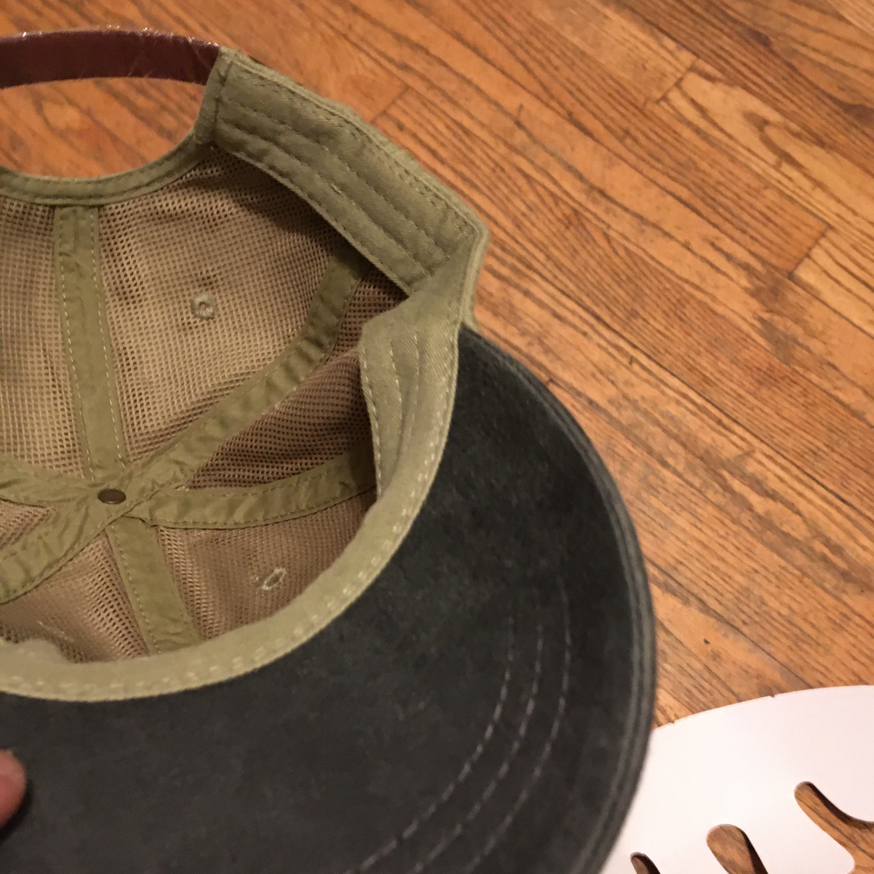 The 'MILLIGAN' Two Tone Dad Hat.  A classic.  All time.  Never goes bad.  No expiration date.  Always gold my friends!  Delivered in a khaki cap with either a washed blue or washed black bill and button at far top.  Features a genuine leather strap with gold-colorored clasp at rear.  Super breathable liner on the inside sets this hat a couple notches above the rest.  This thing is yer' go-to.  Just ask a dude in a tractor with a/c...and possibly a radio too.