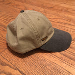 Load image into Gallery viewer, The &#39;MILLIGAN&#39; Two Tone Dad Hat.  A classic.  All time.  Never goes bad.  No expiration date.  Always gold my friends!  Delivered in a khaki cap with either a washed blue or washed black bill and button at far top.  Features a genuine leather strap with gold-colorored clasp at rear.  Super breathable liner on the inside sets this hat a couple notches above the rest.  This thing is yer&#39; go-to.  Just ask a dude in a tractor with a/c...and possibly a radio too.
